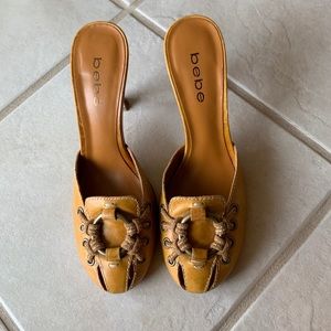 Bebe size 6.5 tan heels with metal ring and “lace.”